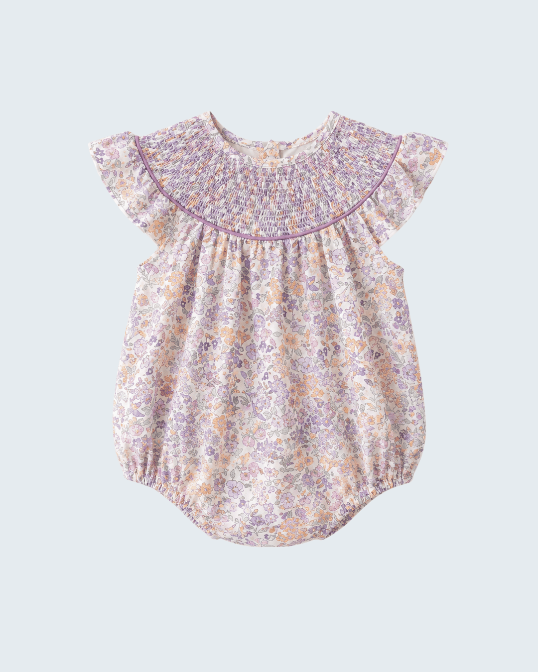 Baby romper with floral pattern on a light blue background