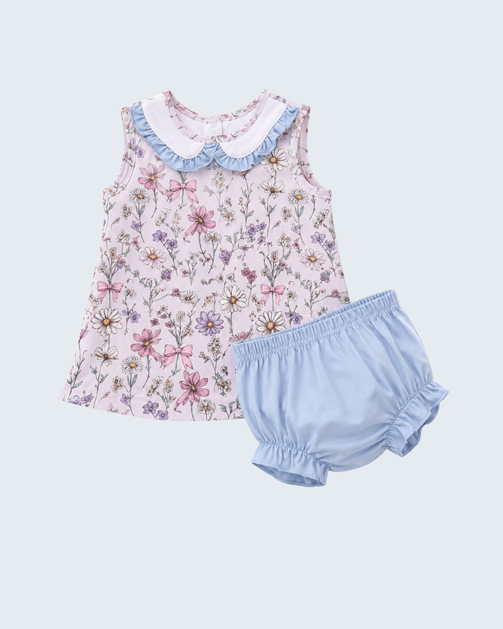 Floral top and light blue bloomers set on a light gray background
