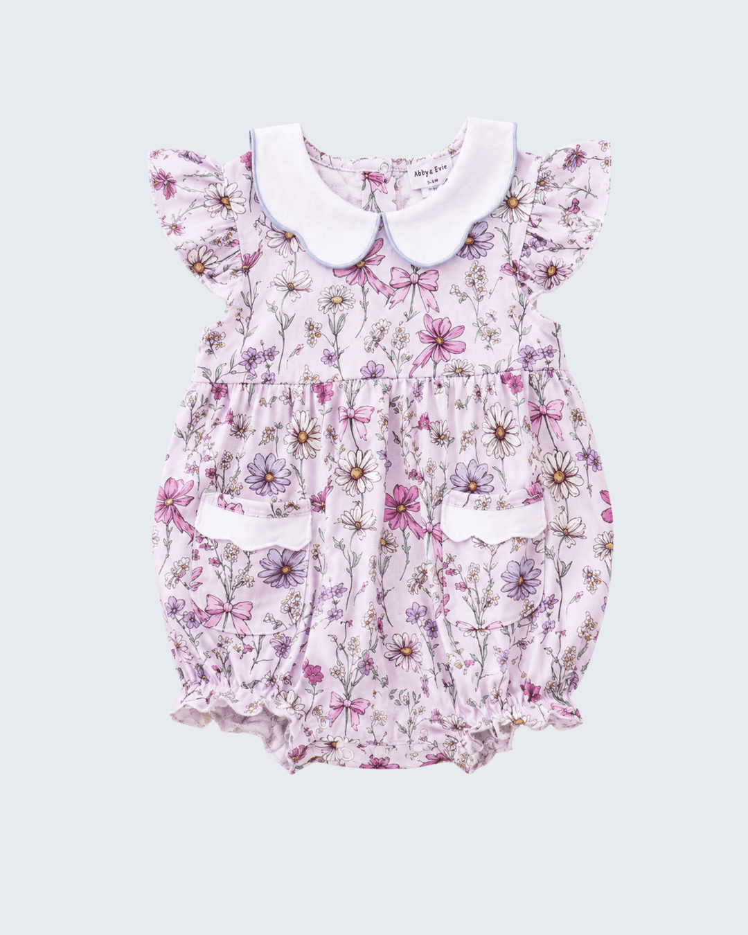 Floral baby romper with a white collar on a light purple background