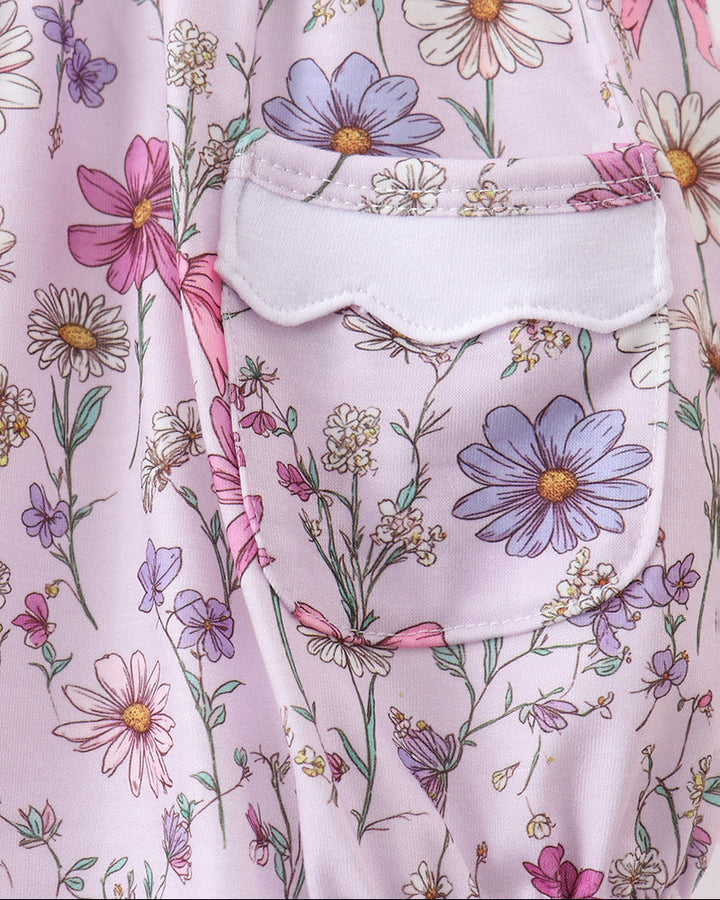 Floral-patterned fabric with pink and purple flowers on a light pink background