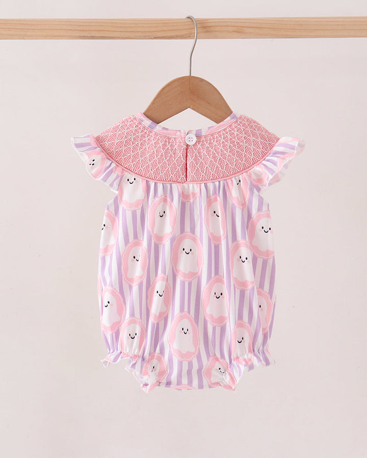 A baby romper with a pink smocked collar and a pink, purple, and white striped body with cute bunny face prints, hanging on a wooden hanger.