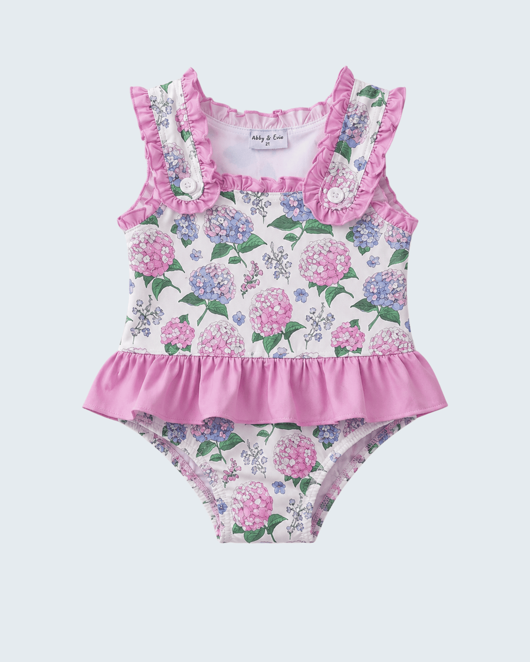 Floral swimsuit with ruffled details on a light purple background