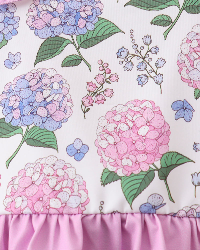 Floral patterned fabric with pink, blue, and green flowers on a white background.