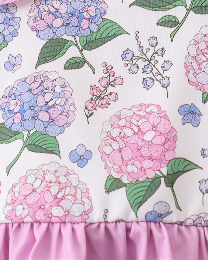 Floral patterned fabric with pink, blue, and green flowers on a white background.