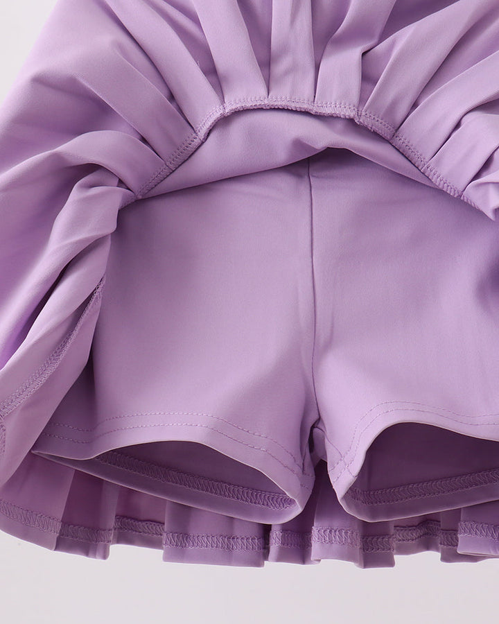 Close-up of a purple ruffled garment on a light background