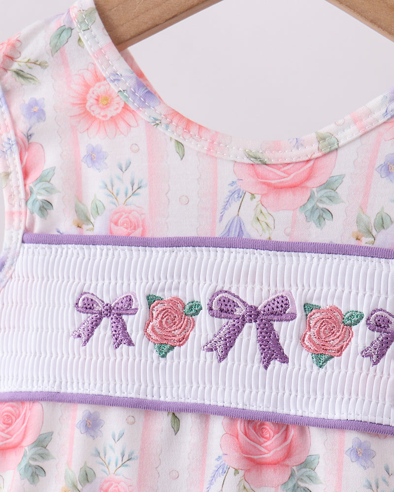 Floral dress with embroidered details on a wooden surface