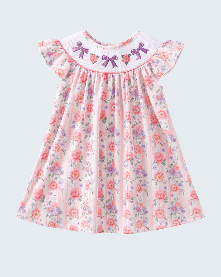 Floral dress with bow details on a light gray background
