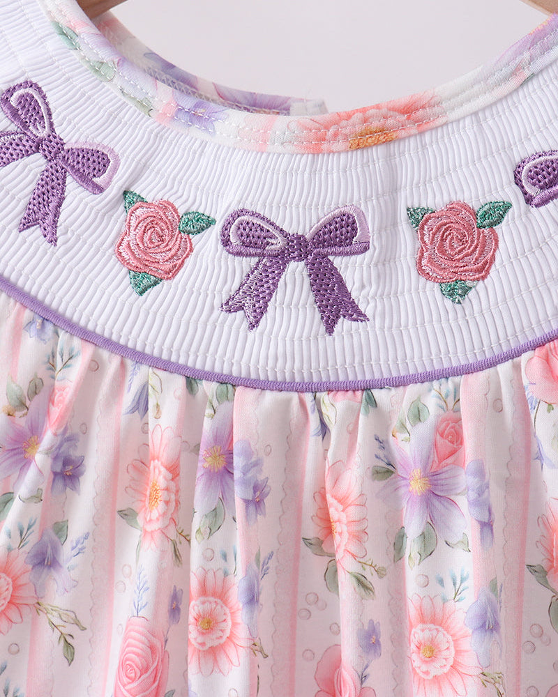 Close up image of embroidery of blows and roses