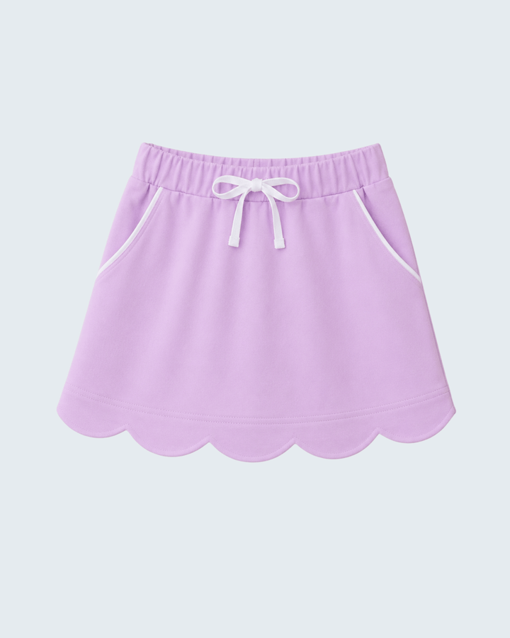 A light purple skort with a scalloped hem, white drawstring, and white piping details, shown against a light gray background.