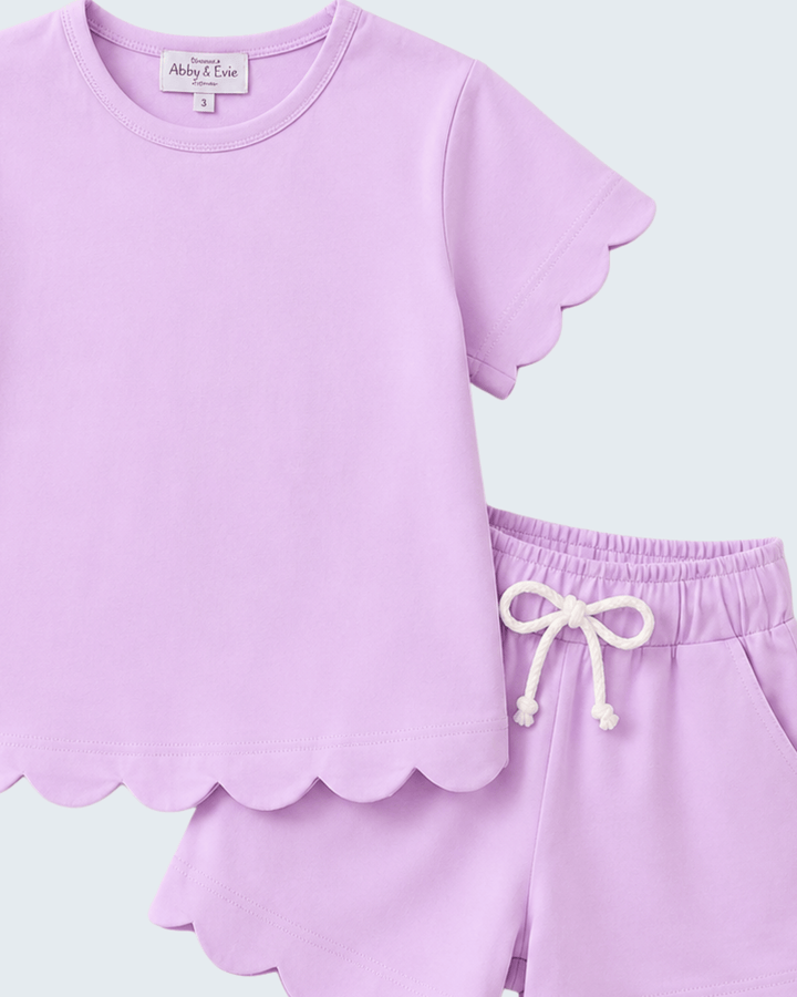 Lavender shorts set with scalloped edges on a light green background