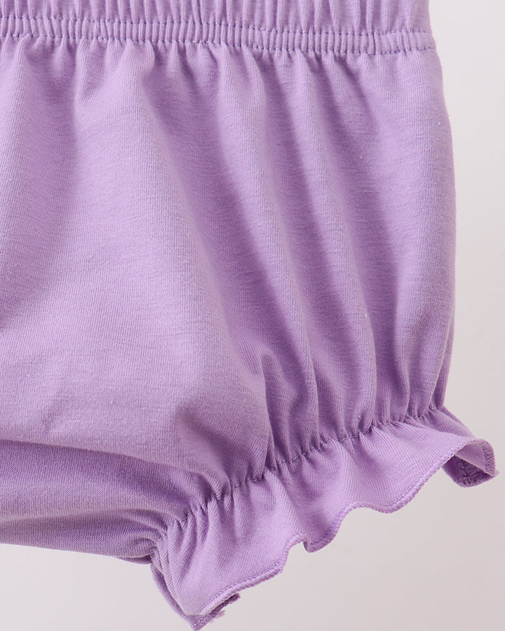 Purple baby bloomers on a light gray background