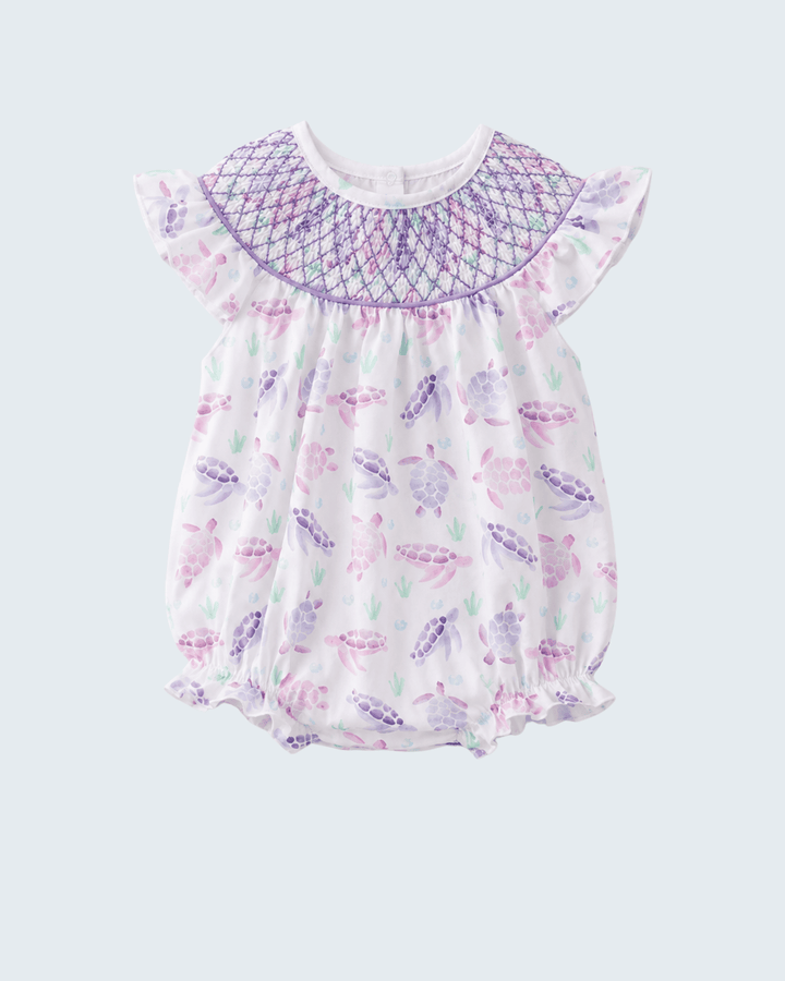 Baby romper with butterfly pattern on a light purple background