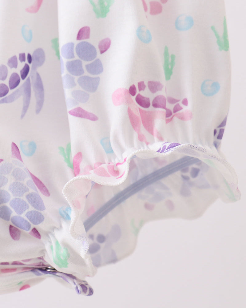 Baby romper with colorful turtle design on a white background