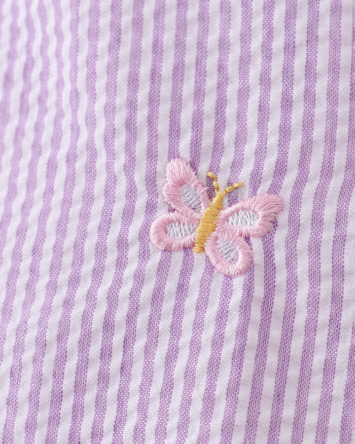 Butterfly embroidered on purple and white striped fabric