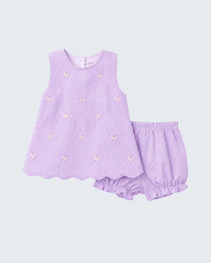 Lavender seersucker dress and bloomers set on a light purple background