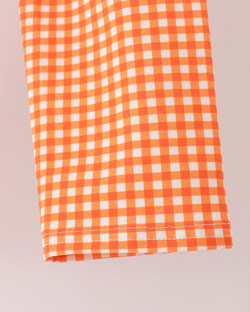 Orange and white gingham pants with stitched hem