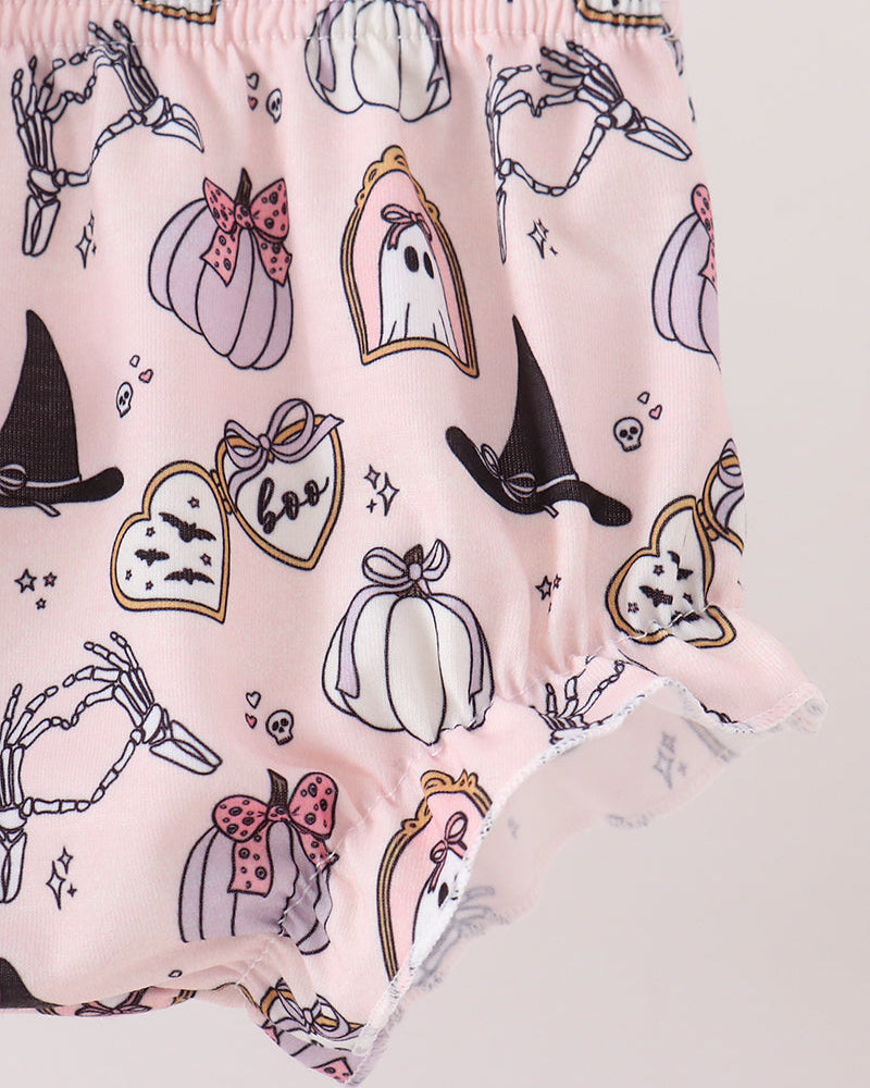 Pink ruffled baby shorts with a Halloween print featuring pumpkins, ghosts, witch hats, skeleton hands, and bats.