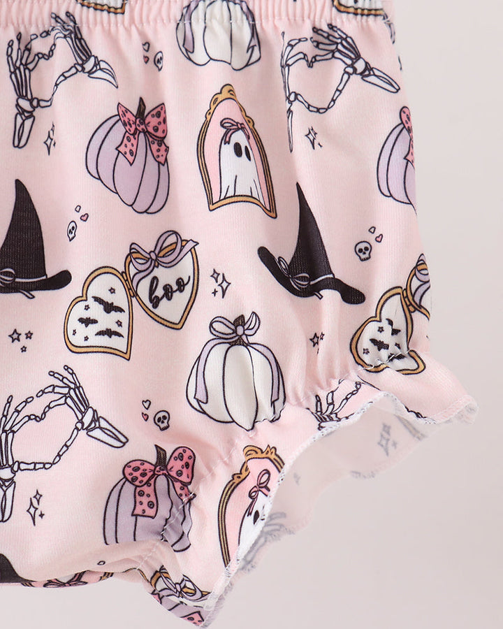 Pink ruffled baby shorts with a Halloween print featuring pumpkins, ghosts, witch hats, skeleton hands, and bats.