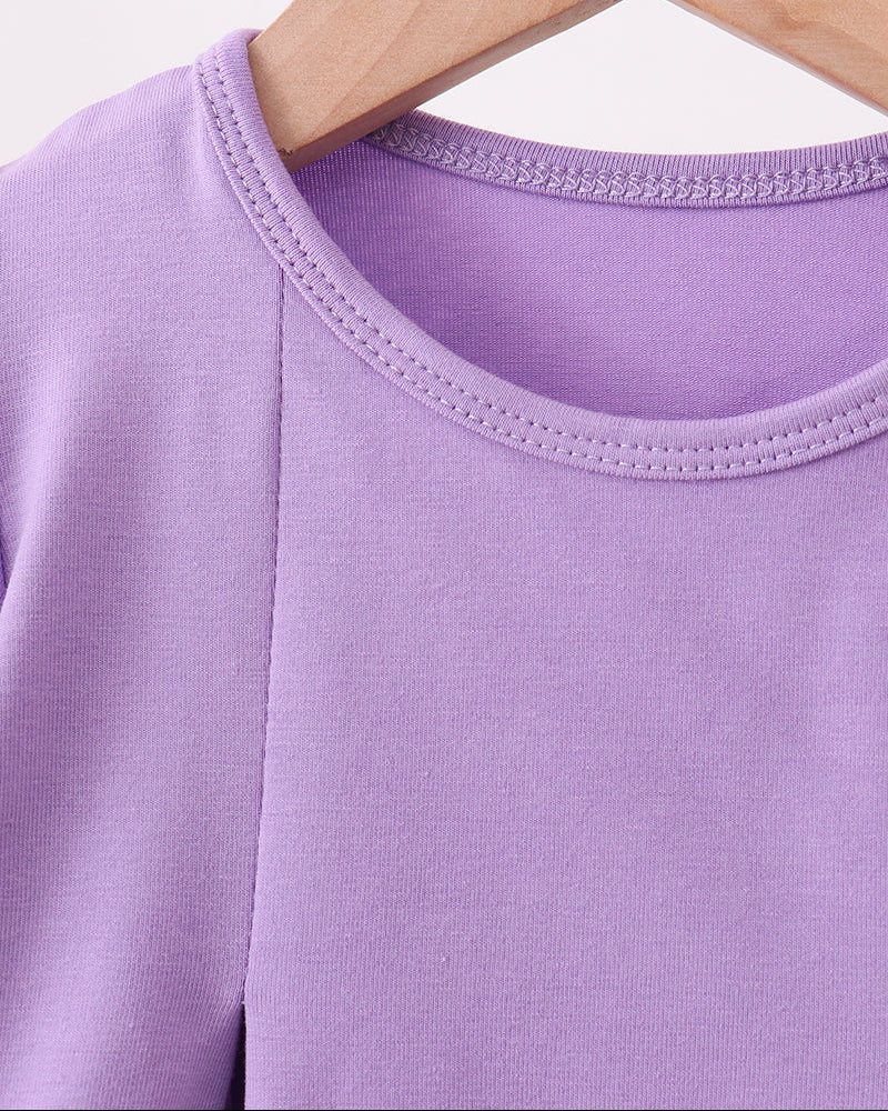 Purple tunic neckline with stitched trim and side seam construction