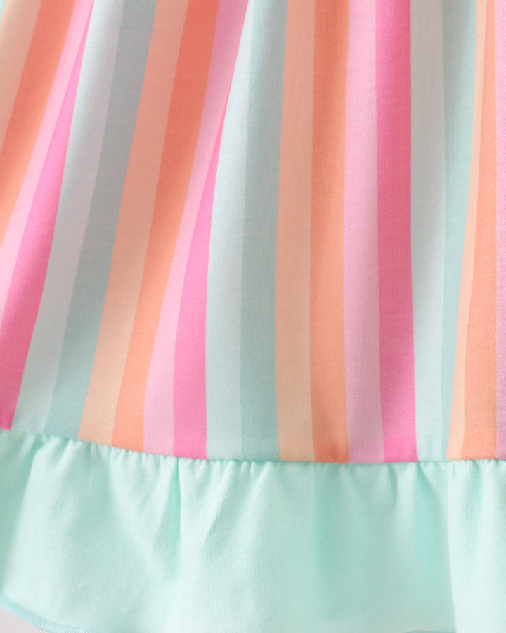 Close-up of a dress with colorful striped pattern on a light background