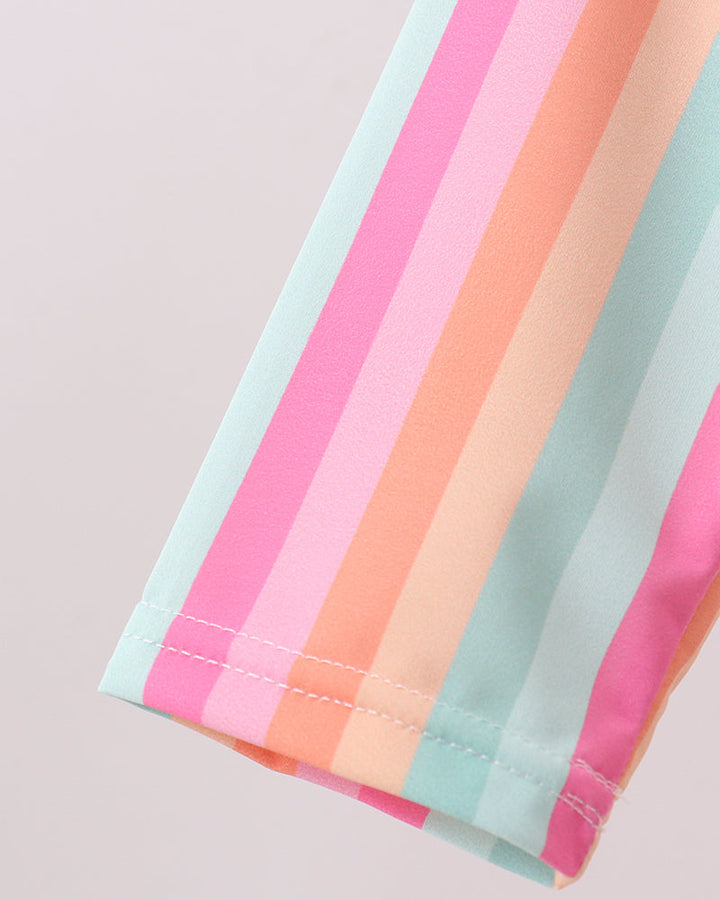 Stack of colorful striped paper on a light background