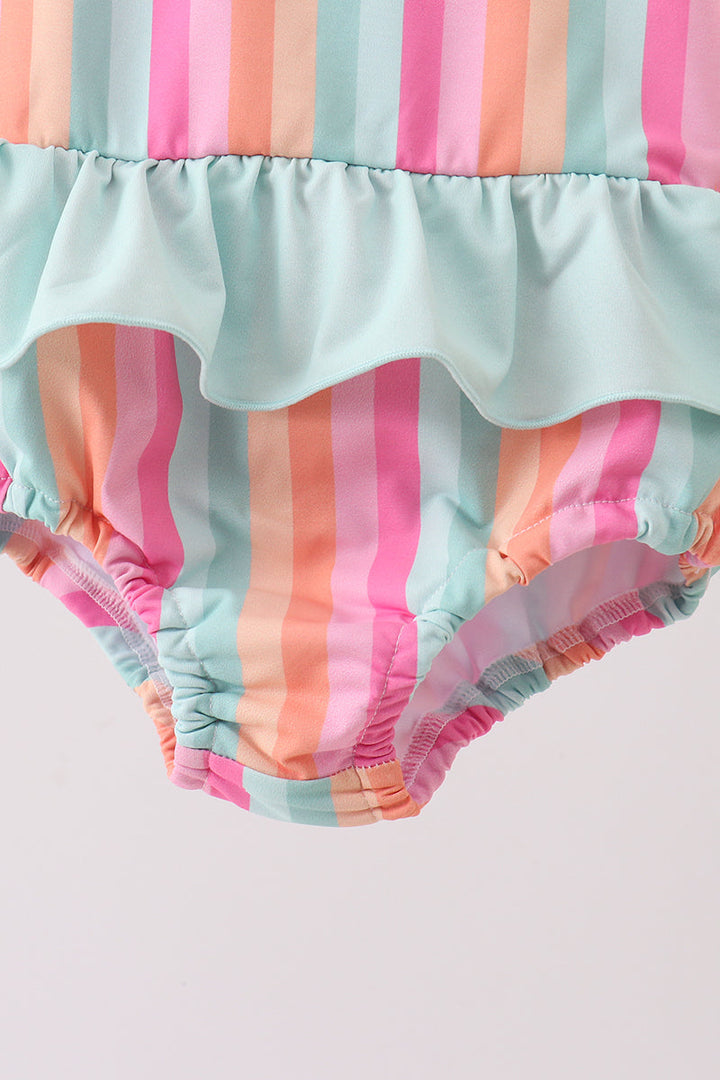 Colorful striped baby bloomers on a light gray background
