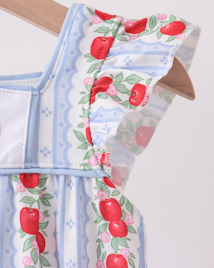 Light blue romper with red apple pattern on a white background