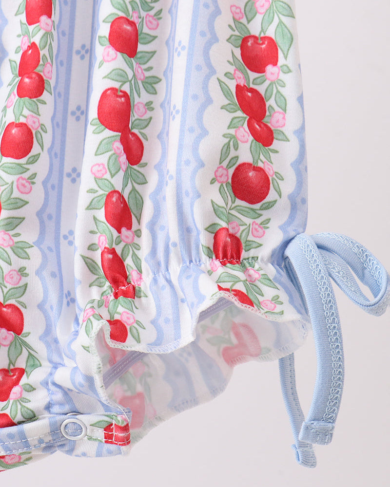 Baby outfit with red apple pattern on a white background
