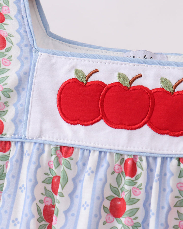 Dress with red apple design on a white background