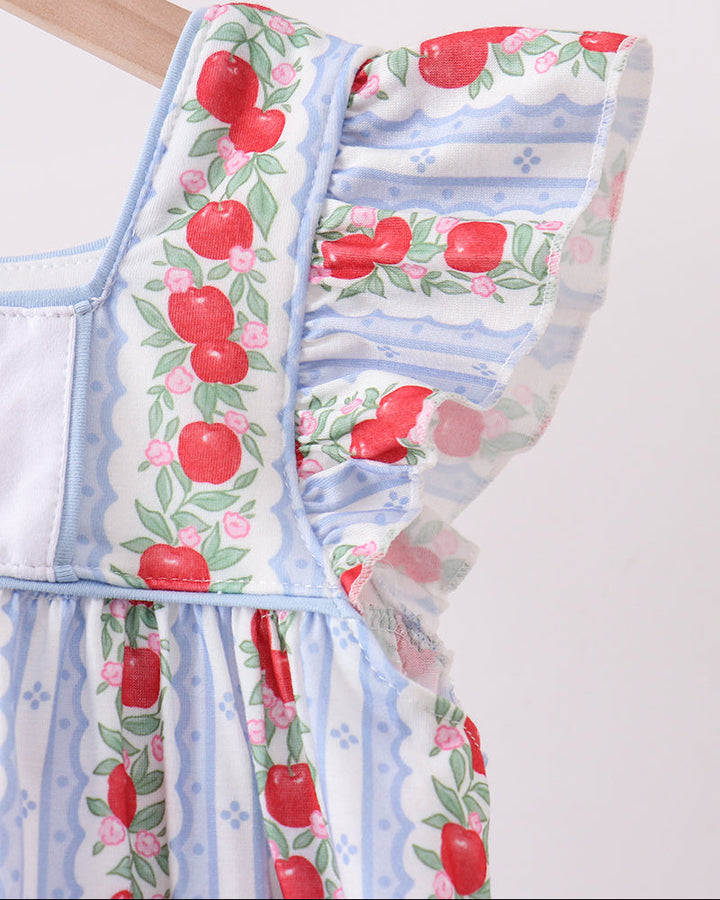 Dress with apple pattern on a plain background