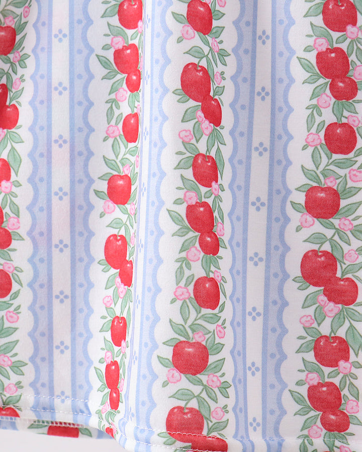 Fabric with red apple pattern on a striped background