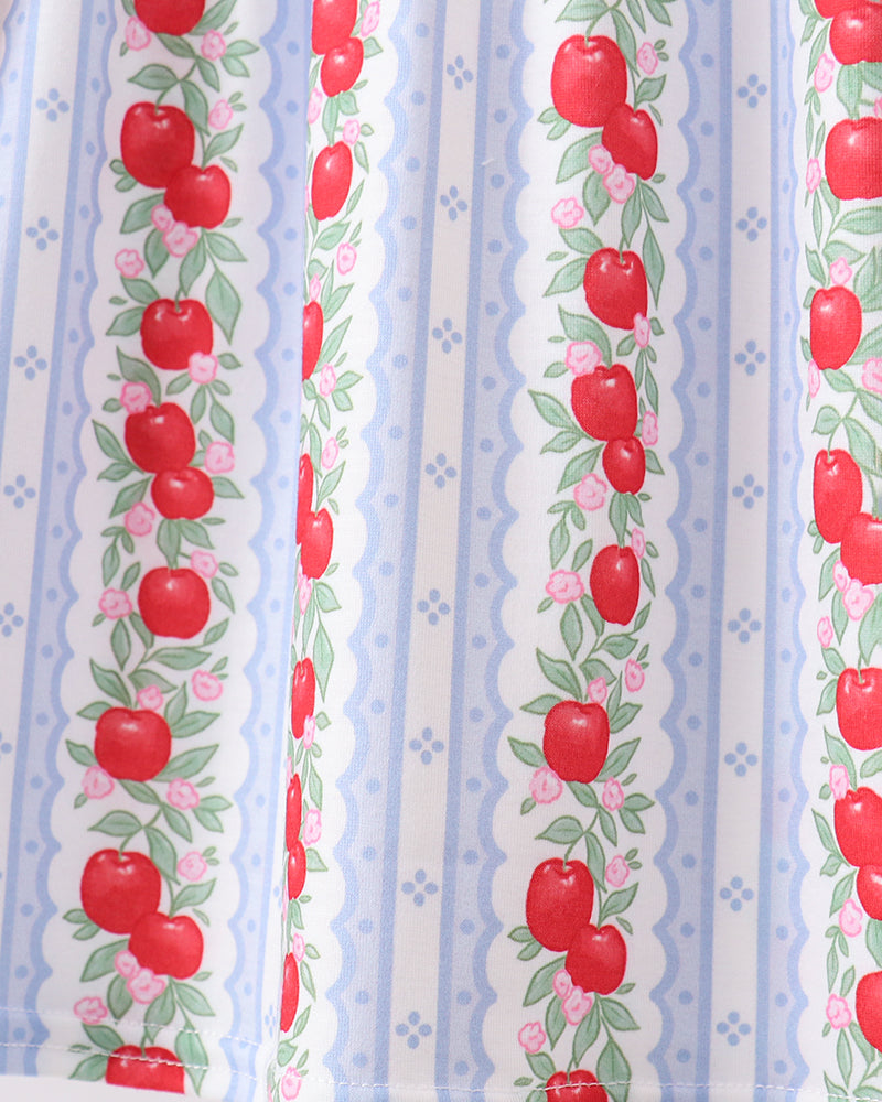 Fabric with red apple pattern on a blue and white striped background