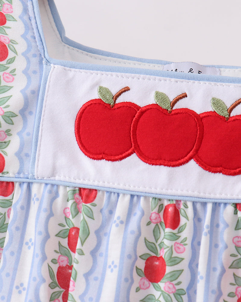 Dress with red apple design on a white background