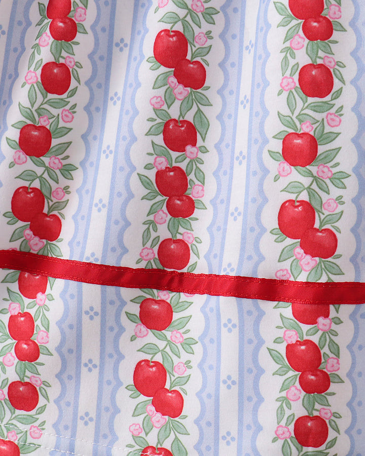 Fabric with red apple pattern on a blue and white striped background