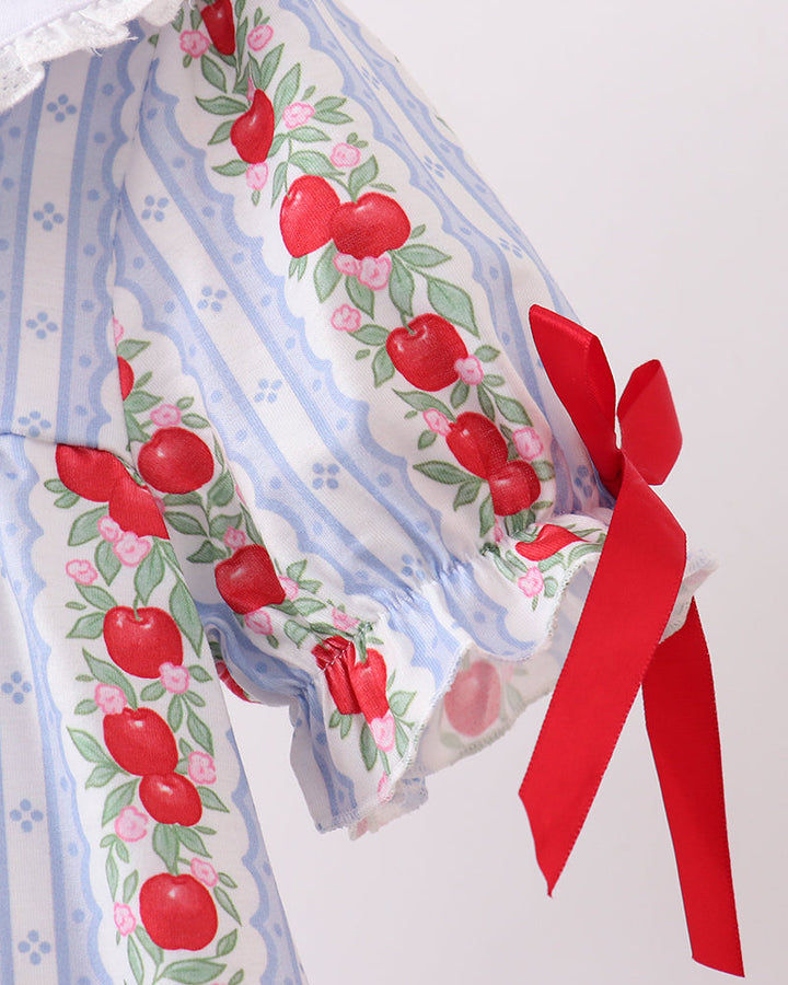 Fabric with red apple pattern and a red ribbon on a white background