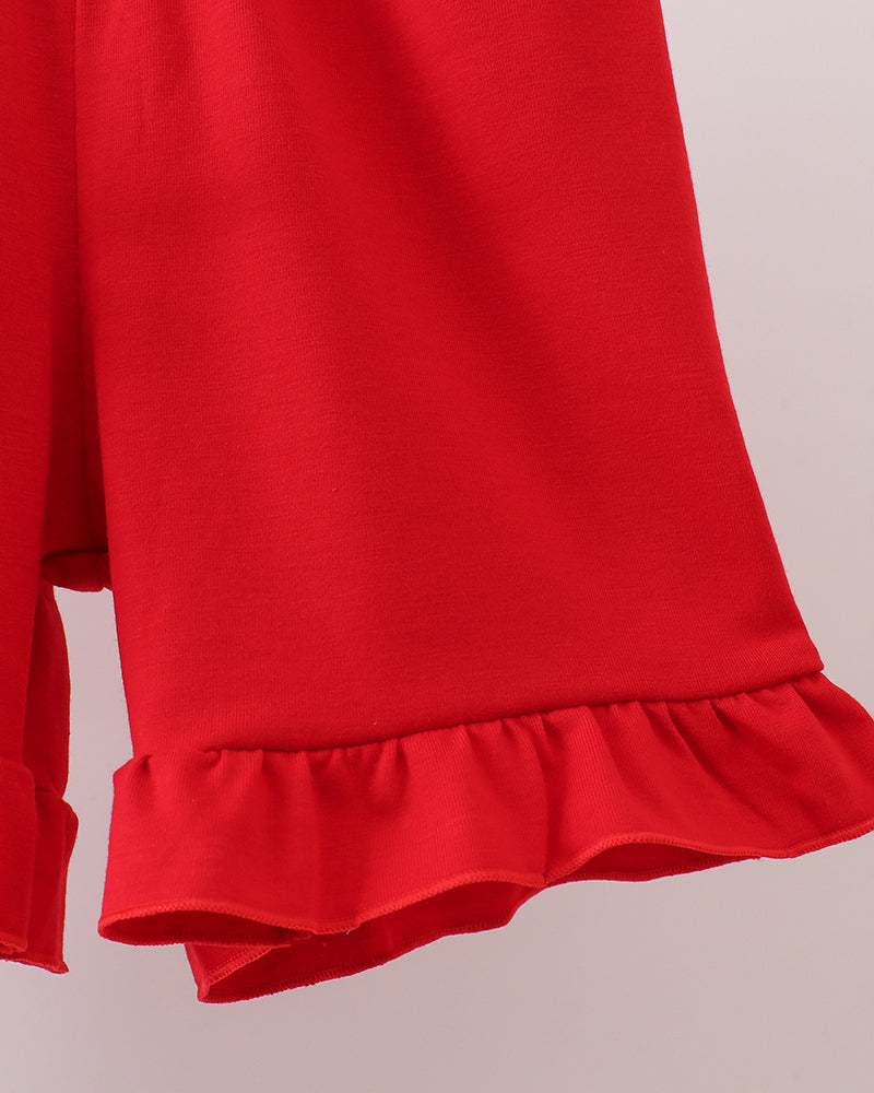 Red dress with ruffled hem on a light gray background