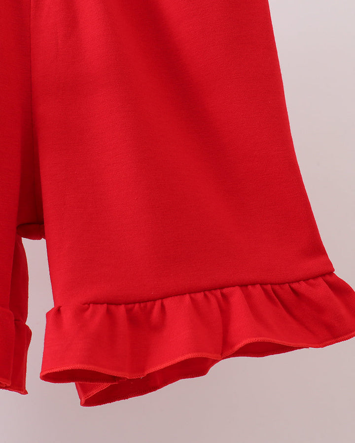 Red dress with ruffled hem on a light gray background