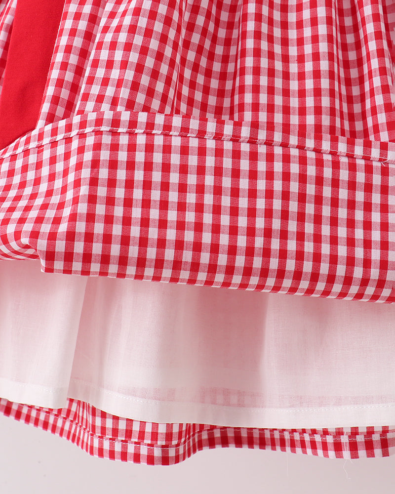 Red and white checkered fabric with a light pink overlay on a plain background