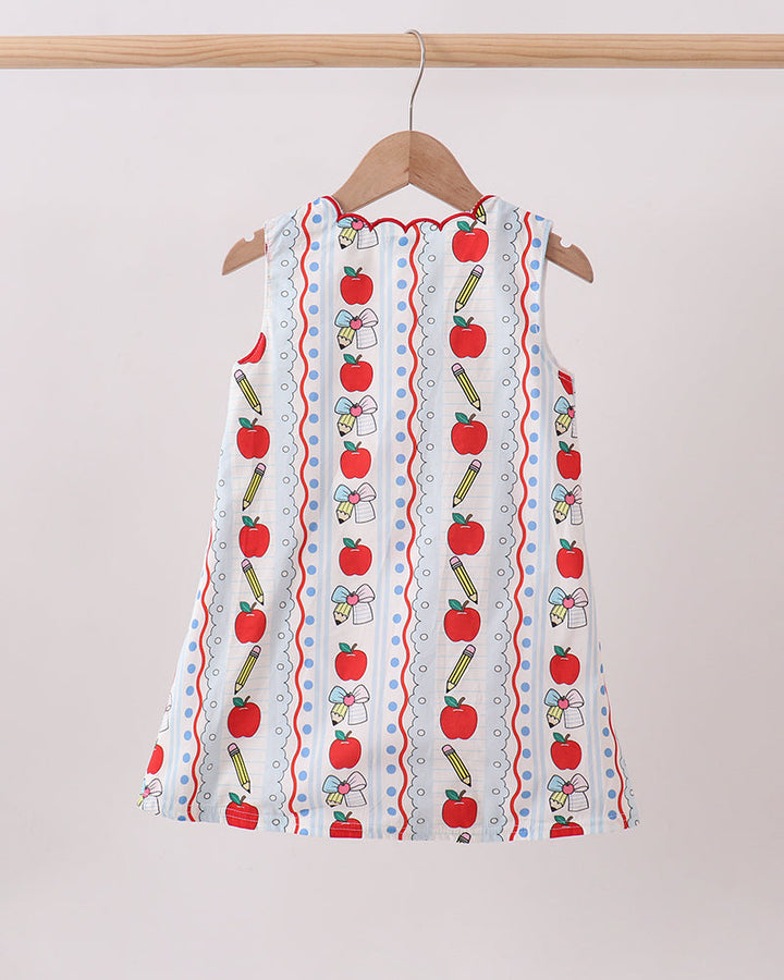 White sleeveless kids dress with vertical apple and pencil pattern and red scalloped hem