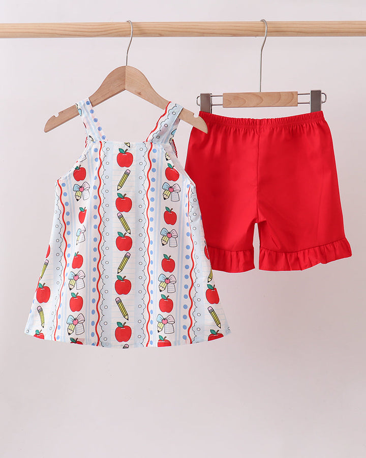 Apple print ruffle top and red shorts set, front view on hangers