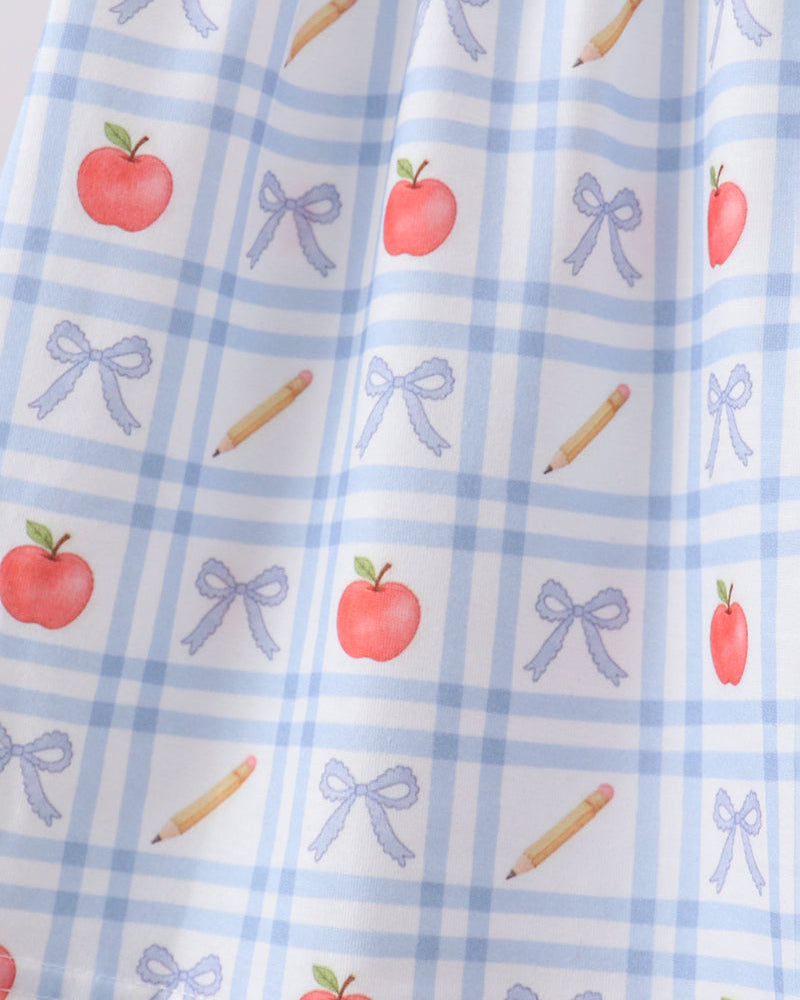 Girls light blue dress fabric with red apples, blue bows, and candy cane icons
