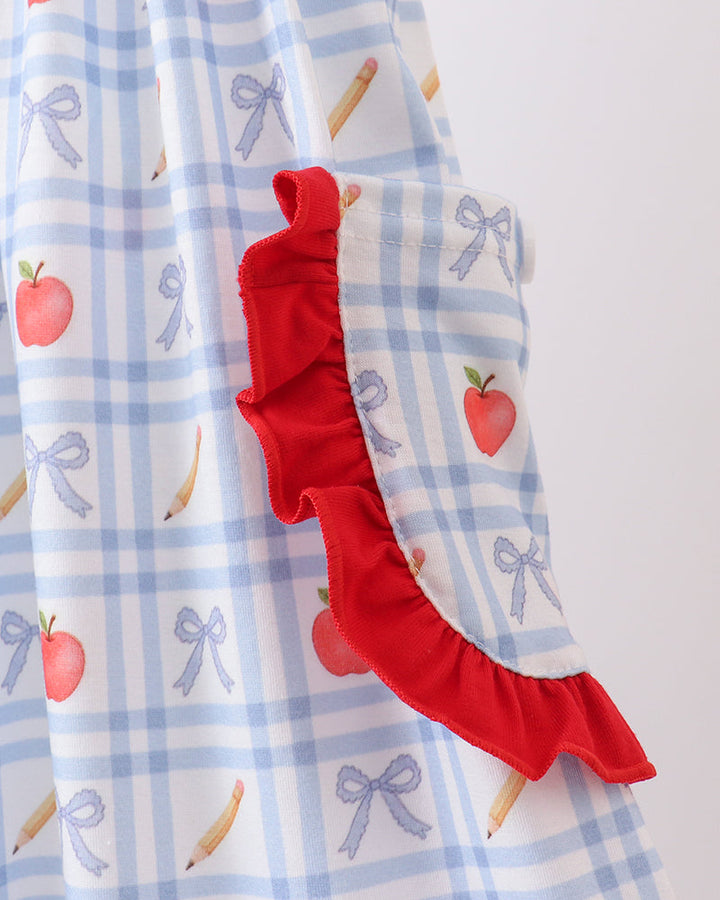Sleeve cuff detail: blue check fabric with apple print and red ruffle trim
