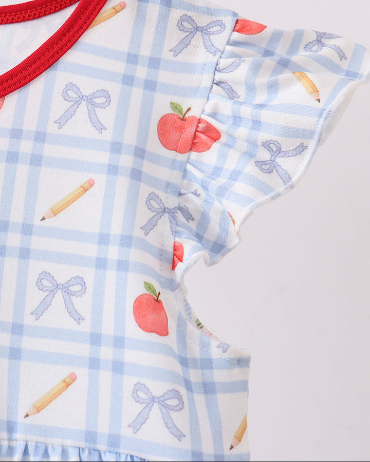 Blue check fabric with apple, bow, and candy prints; red collar trim