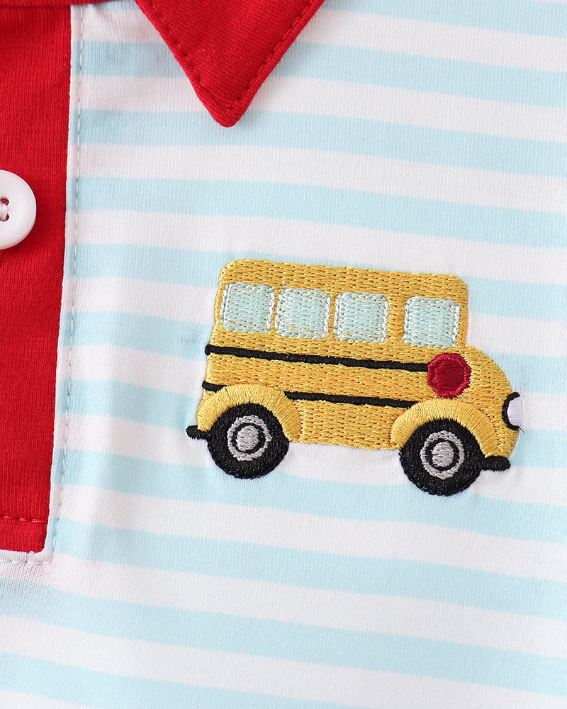 Close-up of blue striped shirt with red collar and embroidered yellow bus patch