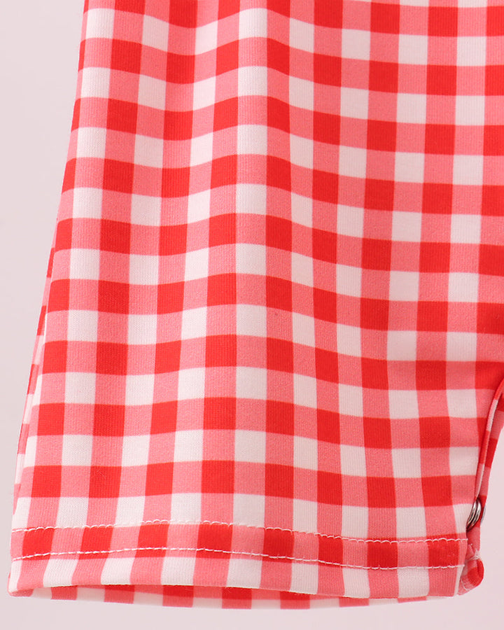 Red plaid romper with snap closure