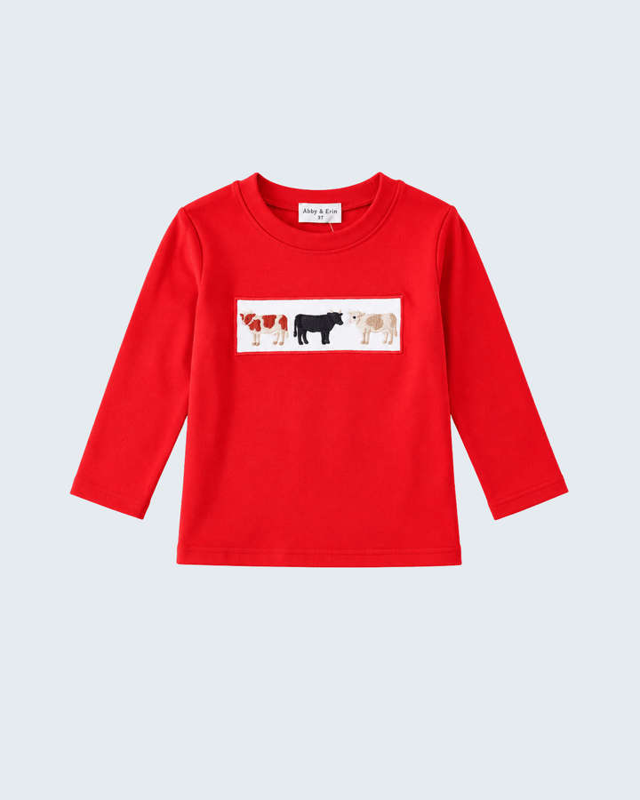 Red long-sleeve top with cow-themed embroidered chest patch, crew neck