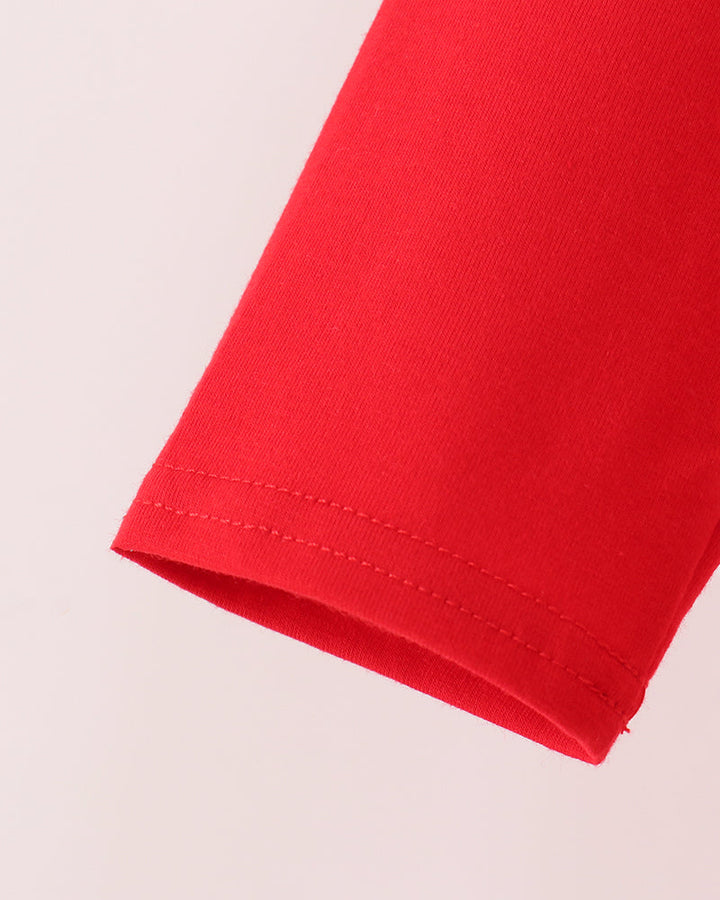 Red top sleeve hem with visible stitched edge