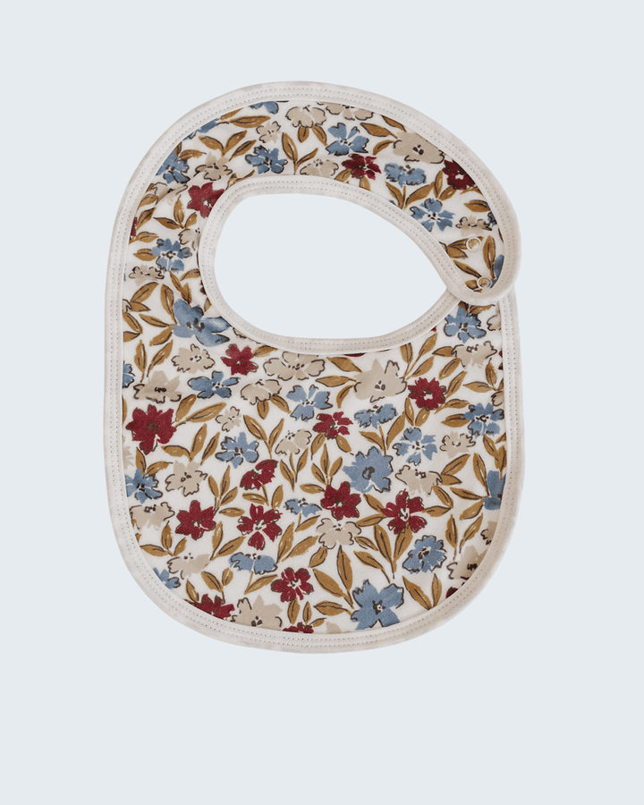 Floral-patterned baby bib on a light gray background