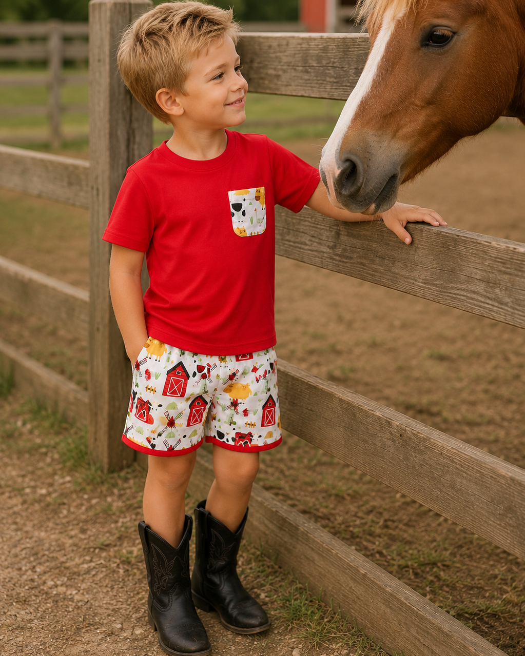 Young boy in shorts and cowboy boots is looking at a horse