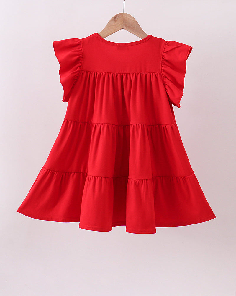 Red dress with ruffled sleeves on a hanger against a white background
